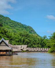 Fototapeta premium Tropical beach houses on the River Kwai in Thailand.Wooden floating raft house in river Kwai Kanchanaburi, Thailand