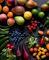 Multiple fruit and vegetable assortment on a black background