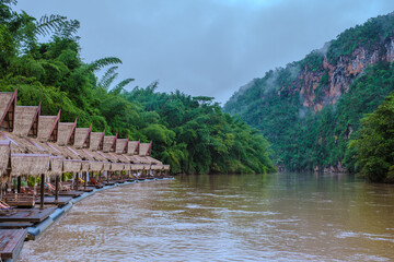 Obraz premium Tropical beach houses on the River Kwai in Thailand.Wooden floating raft house in river Kwai Kanchanaburi, Thailand at sunset