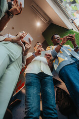 Diverse business team brainstorming and collaborating in a modern office. They write ideas on sticky notes, discussing innovation, growth, and strategy.