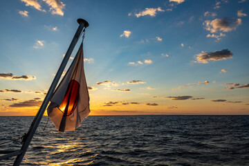 Japanese flag in the ocean at sunset