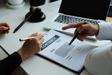Judge gavel with Justice lawyers having team meeting at law firm in background. Concepts of law.
