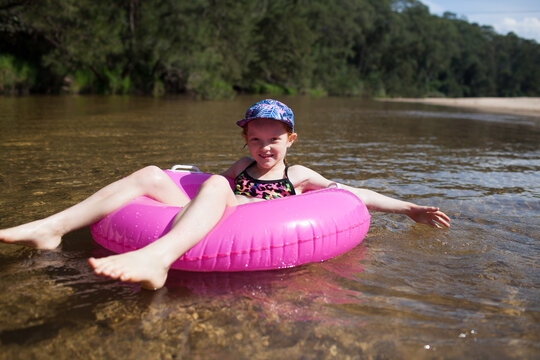 Girl floating on a river in an inflatable ring