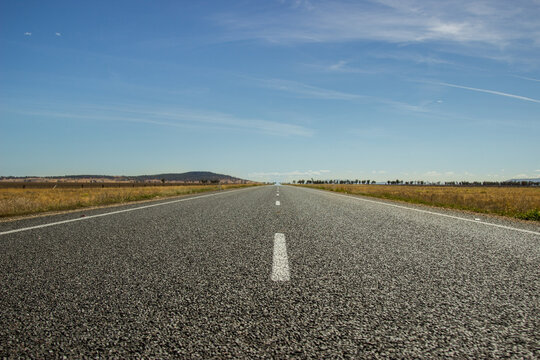 Down low view of a dead straight road