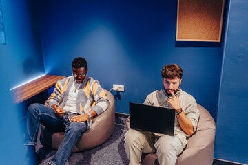 Multi-generational team collaborate confidently in a co-working space, driving profit growth. Diverse employees solve problems, gather data, and work together on tasks for a successful small company.