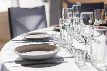 Serving and decor of the wedding round table on the outdoor veranda.