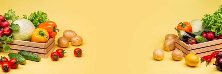 A set of ripe healthy vegetables for a healthy diet on a yellow background. Copy space. Cucumbers, tomatoes, eggplants, peppers, cabbage, lemons, radishes and lettuce.