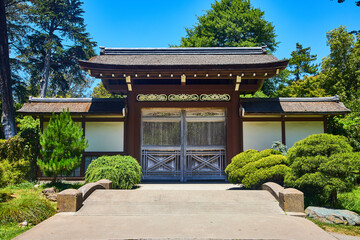 Closed doors leading to entrance of Japanese Tea Garden on bright summer day with blue sky