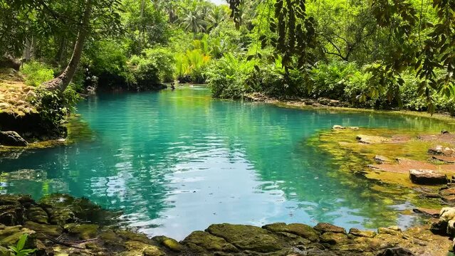 Turquoise water surrounded by tropical forest. Beto Lagoon in Barobo, Surigao del Sur. Philippines.