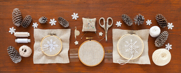 Handmade gifts for Christmas. Embroidery of beautiful snowflakes on natural canvas in hoop with...