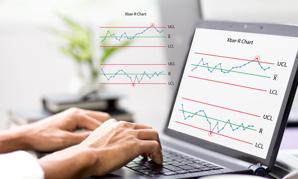 Hand of person work with laptop and monitoring Xbar-R chart graph and analysis  problem red some point at workplace in office