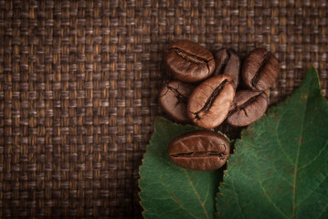 coffee beans and leaves close-up against the background of a bag