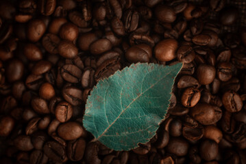 Roasted coffee beans and green leaf