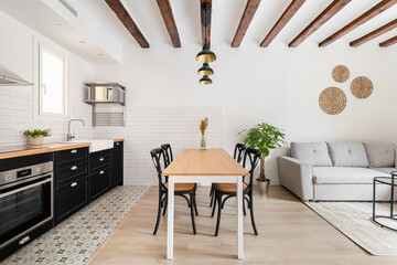 Kitchen and dining area adjacent with living room rest zone
