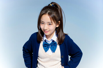 青空をバックに健康的に微笑む女子高生