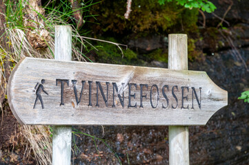 Signpost to the waterfall Tvinnefossen made of wood.