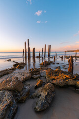 Calm sunset view Port Willunga jetty pylons, South Australia.