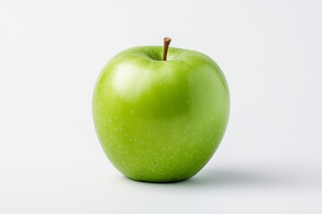 Photo of a fresh and appetizing green apple on a white minimalistic background. Delicious and healthy fruit.