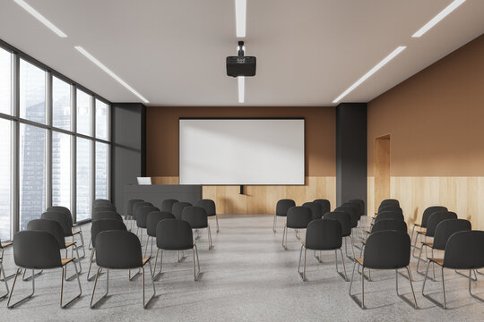 Beige and gray lecture hall interior with projection screen