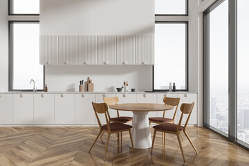 White kitchen interior with round dining table