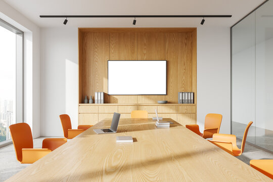 Cozy office conference room interior with meeting table and mock up tv display