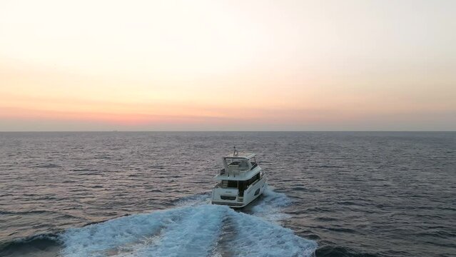 White yacht crusing at sunrise in the Mediterranean waters of Rhodes island, Greece