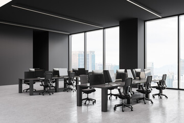 Dark office interior with table and pc monitors in row, panoramic window