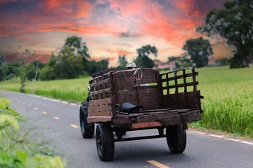 Deurstickers tractor with old trailer on a field © Bankphotographer