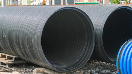 Black plastic pipes of large diameter for repair of communications. Pipes for water transportation...