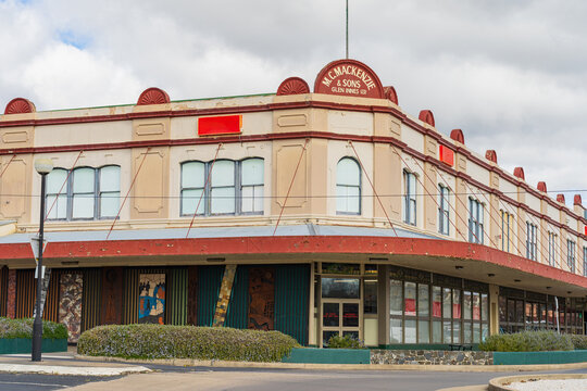 An old fashioned department store building with wide verandas on street corner
