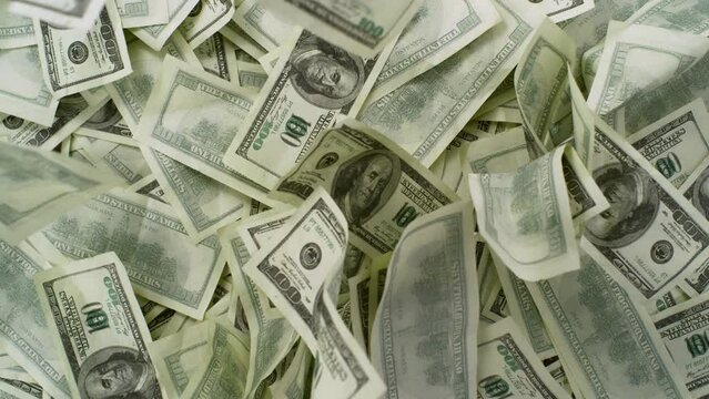 Super Slow Motion Shot of Hundred Dollar Banknotes Falling Down on Table at 1000fps.