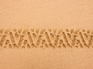 Tyre tread pattern in beach sand