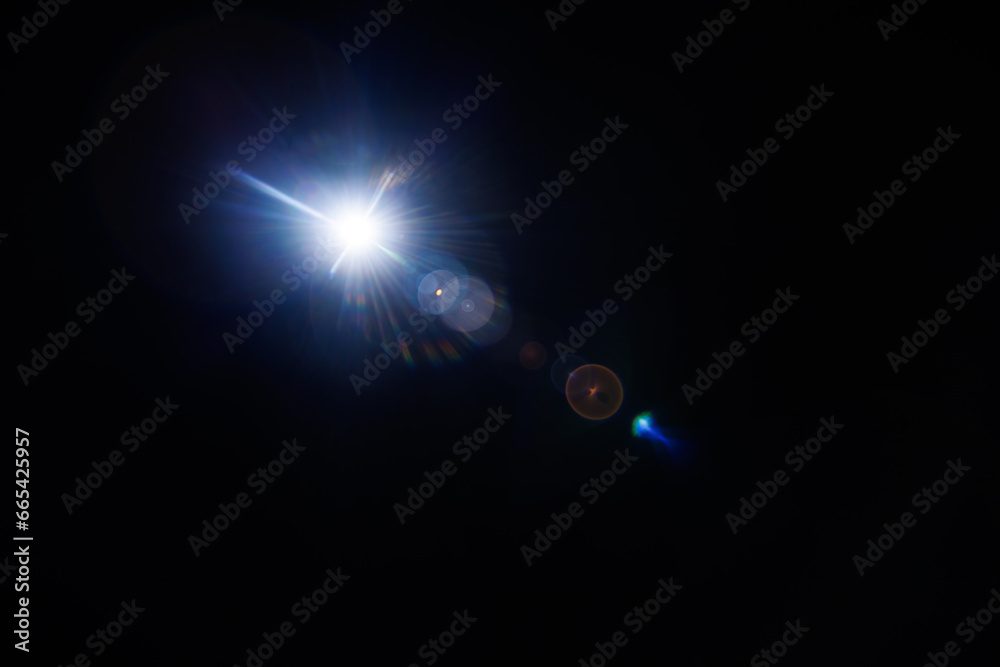 Poster Easy to add lens flare effects for overlay designs or screen blending mode to make high-quality images. Abstract sun burst, digital flare, iridescent glare over black background.