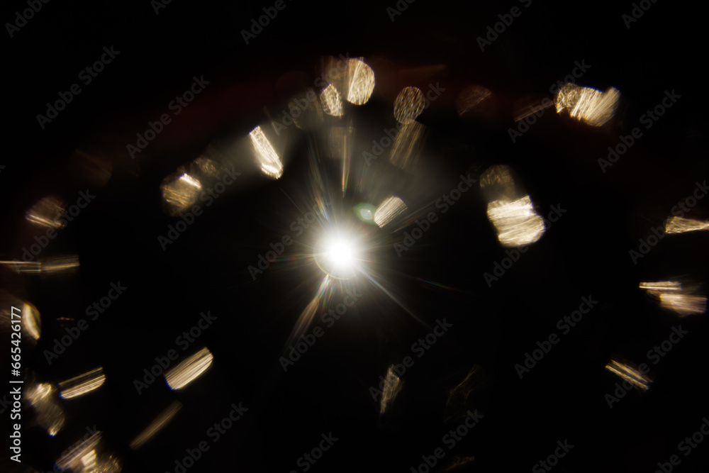 Poster Easy to add lens flare effects for overlay designs or screen blending mode to make high-quality images. Abstract sun burst, digital flare, iridescent glare over black background.