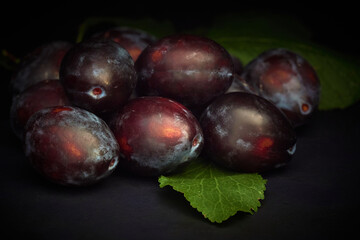 Ripe Prunes on a dark background