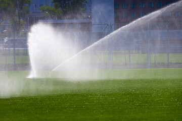 automatic watering of the football field lawn for training.