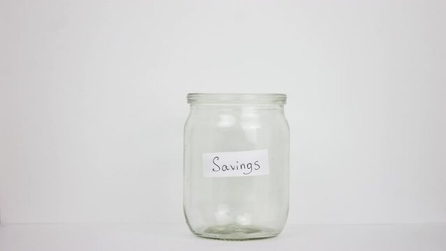Person put many dollar money inside glass jar. Stop motion animation. A lot of usa green banknotes. Save up budget concept. Piggy bank. American bucks cash fund. Accumulate box. Us dolar sum. Pile usd