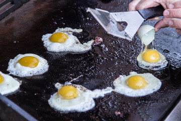Cracking eggs onto the barbie