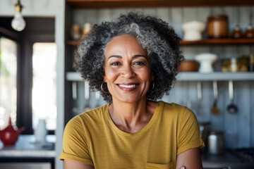 Portrait of elegant confident senior lady with gray hair and beautiful smile in her kitchen.