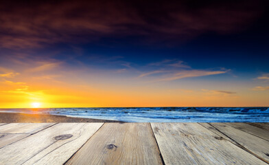Fototapeta na wymiar 浜辺のテーブルと夕日の綺麗なビーチ