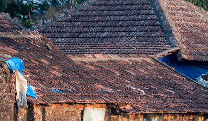 Tiled sloping roofs of traditional rustic houses of a coastal village near Mangalore in Karnataka...
