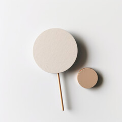 Minimalist Round Label on Stick Flatlay on White Background