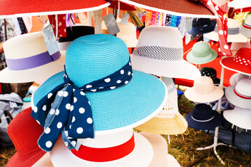 Ladies' hats of different colors on the market. Sale of hats for women in a retail network....