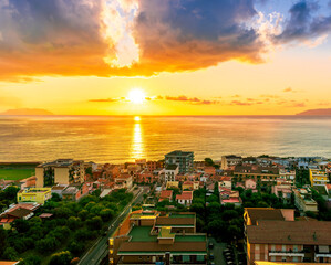Obraz premium panoramic summer travel view from a hill to beautiful sea coast historical town with port, amazing ocean bay and gulf and beautiful mountains with scenic sunset on background.