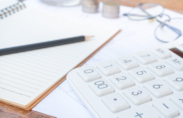 Calculator on financial statements and balance sheet on the desk of an accountant. Concept of accounting and audit business.