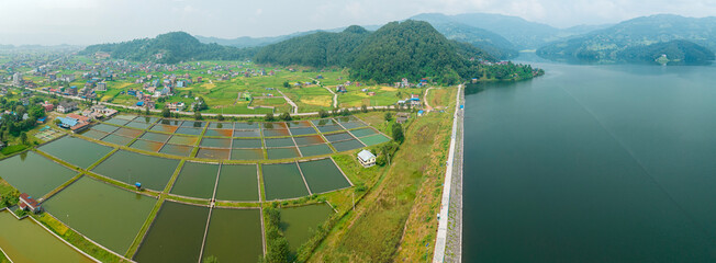 Aerial view of Begnas Lake area, houses and homes surrounded by rice fields, Begnas with a number...