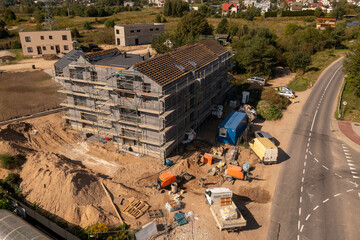 Drone photography of new residential house construction site, scaffolding and roofing
