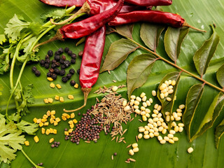 South Indian traditional seasoning ingredients, mustard, curry leaves, black pepper, red chillies,...