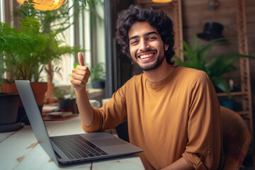 Young man using laptop, smiling