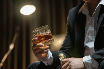 Businessman wearing a suit whiskey glass of liquor.